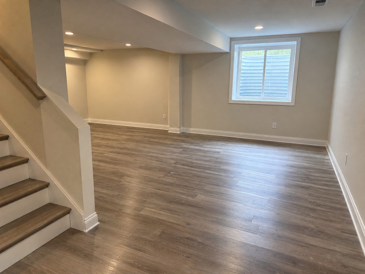 Completed basement with new flooring, trim and paint after a DriForce rebuild