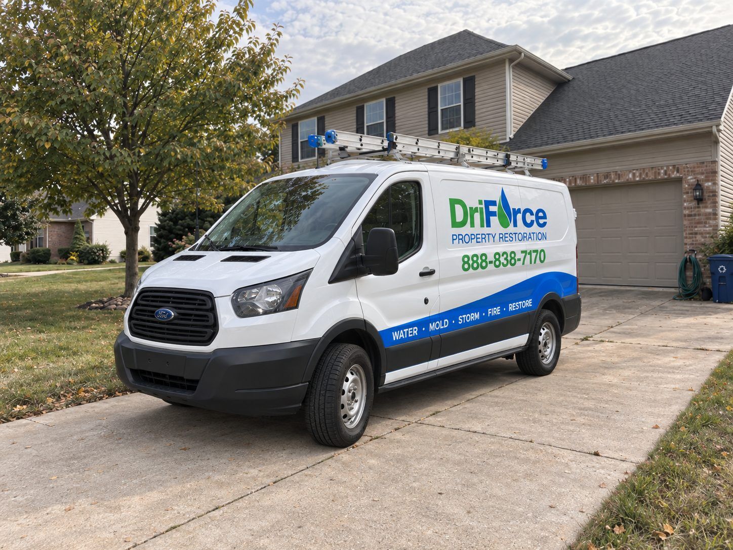 A DriForce Property Restoration service van parked in the driveway of a suburban Michigan home