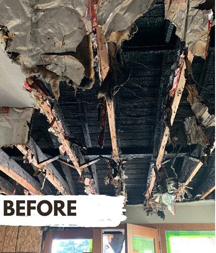 Charred ceiling joists after a house fire - before fire damage restoration by DriForce