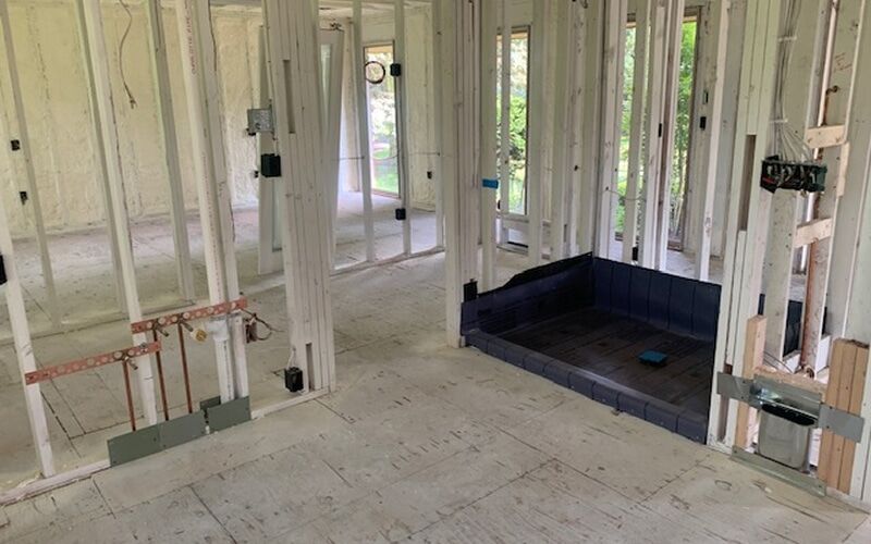 Fire-damaged Michigan home stripped to the framing before reconstruction begins