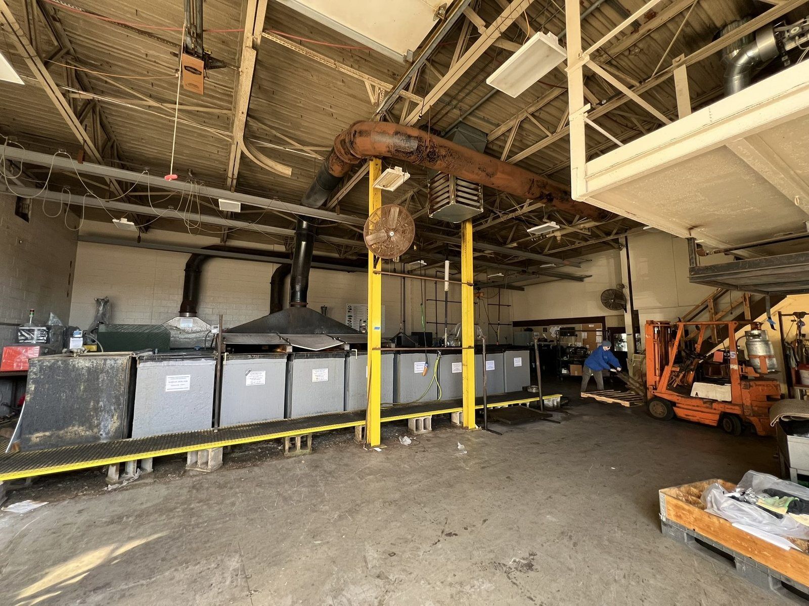Overhead ductwork and process lines in an industrial facility after a fire