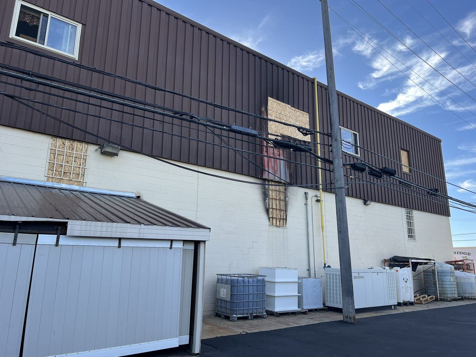 Exterior of a metal-clad industrial building during fire damage restoration