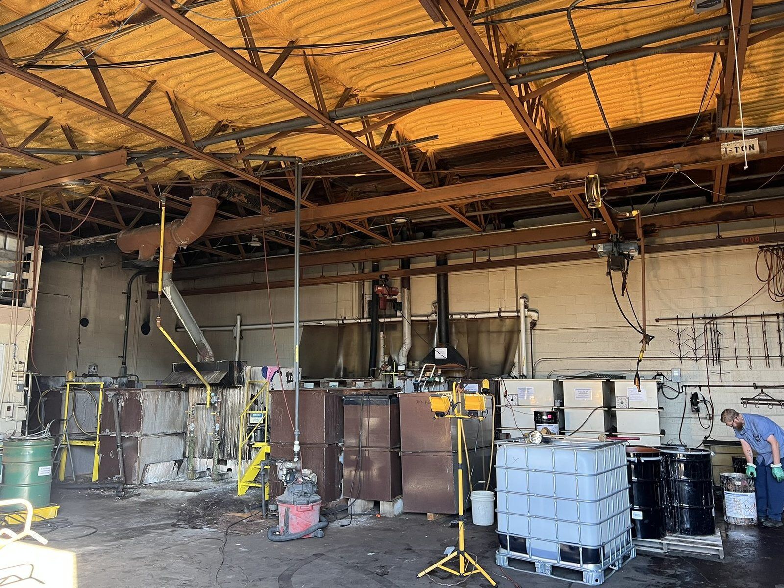Fire-damaged industrial plant floor during a large loss restoration