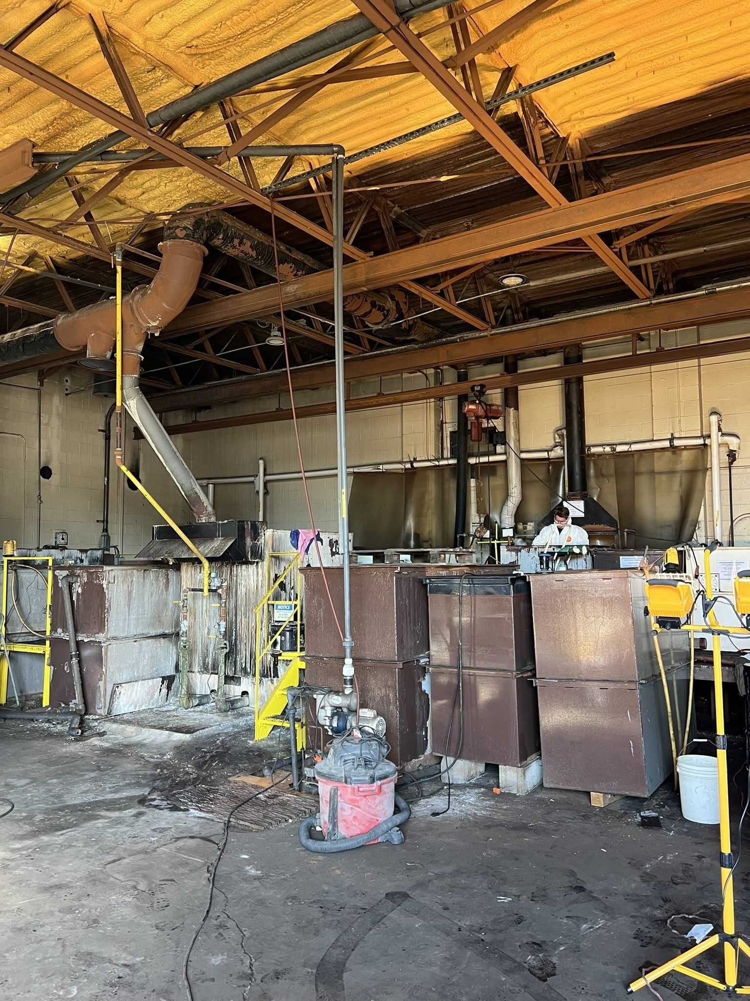 Smoke-damaged structural steel and process equipment inside an industrial plant