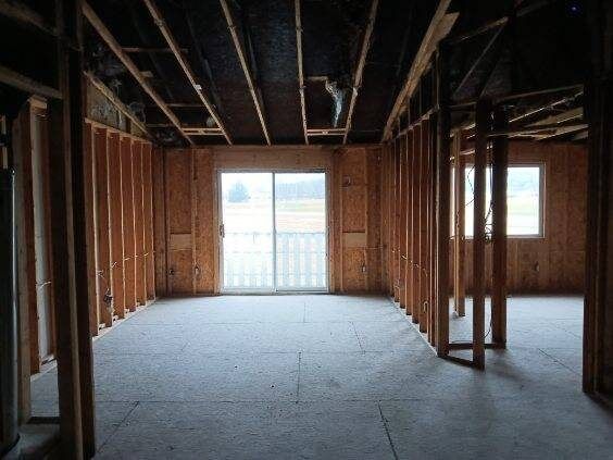 Multi-unit apartment interior stripped to framing after a fire loss at Oakbrooke