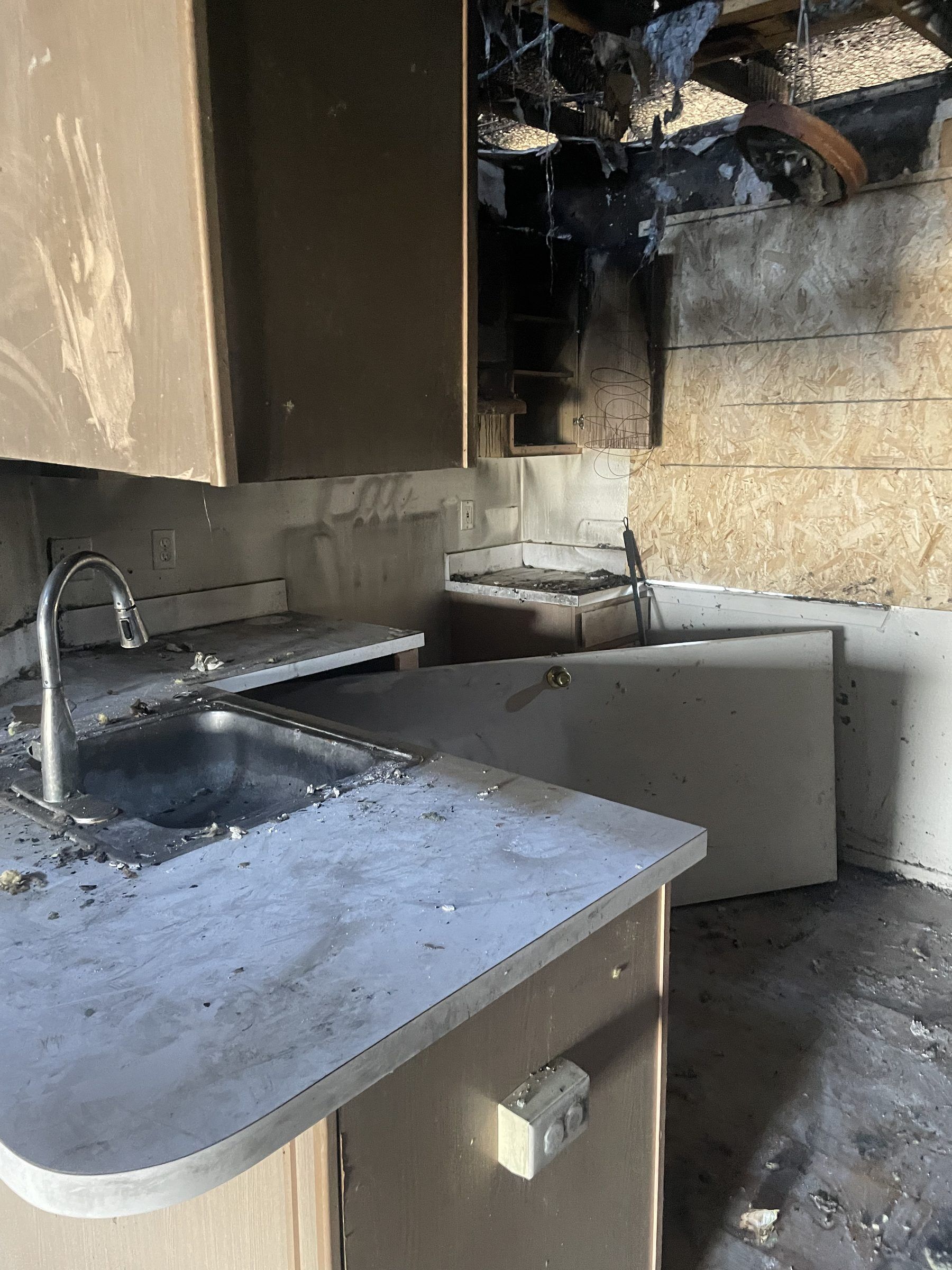 Soot-covered kitchen after a Michigan house fire, before smoke odor treatment by DriForce