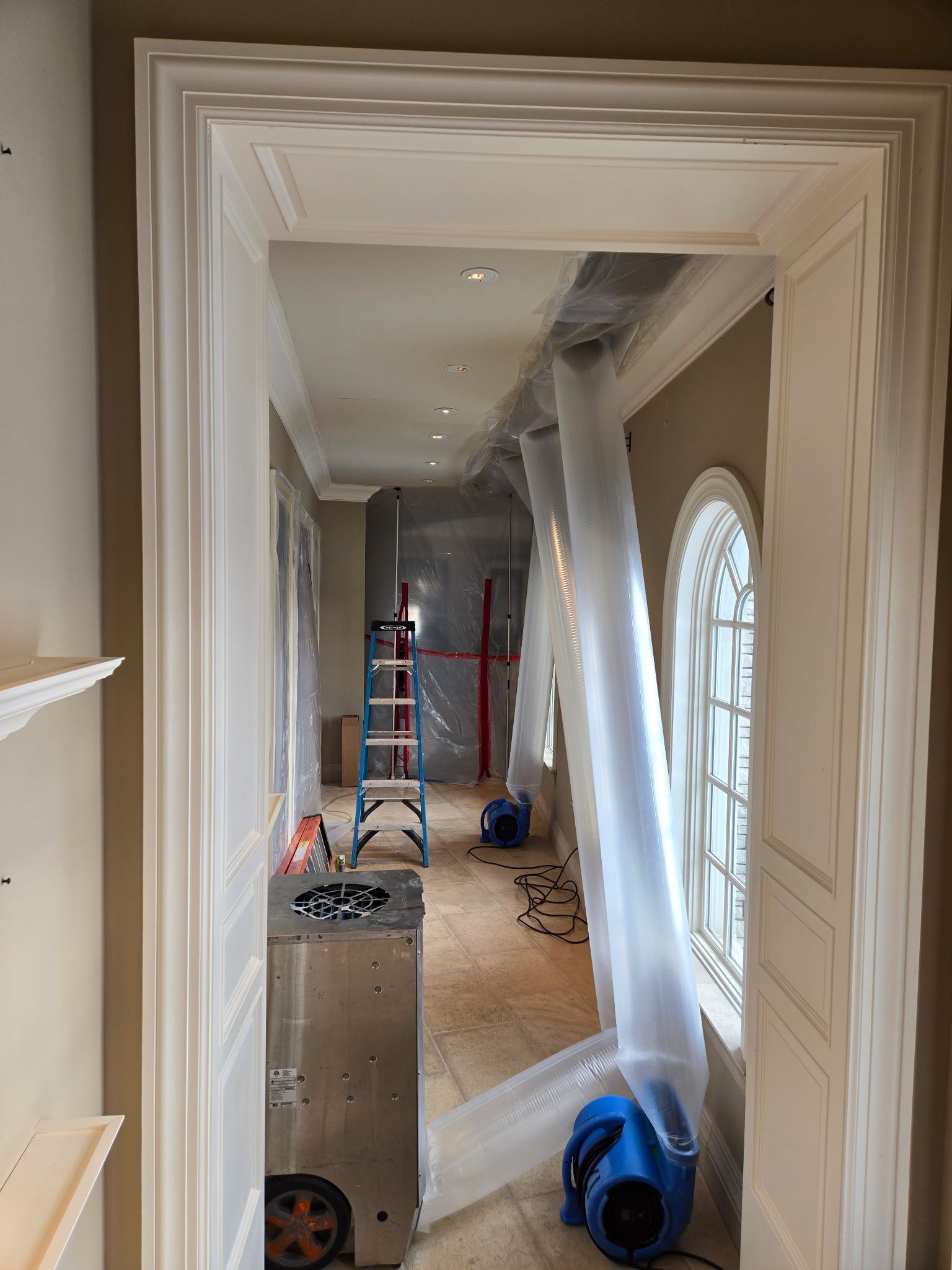 Sealed poly containment and air scrubber during mold remediation in an Oakland County estate home