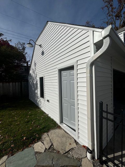 Michigan home exterior restored with new siding after storm damage repairs