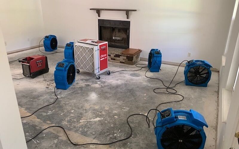 Living room drying array set up during residential water damage restoration in Metro Detroit